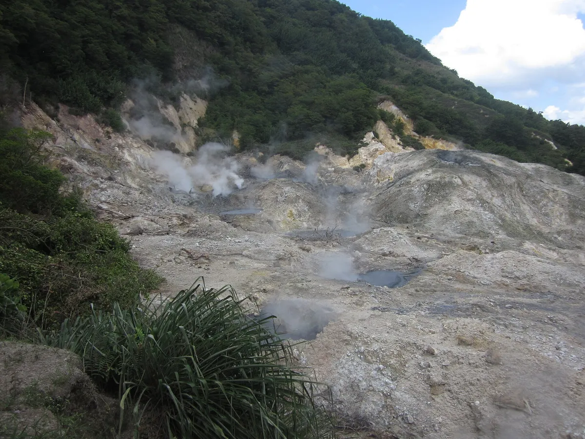 Steam rising from the grey sulphur pools inside the Sulphur Springs drive-in volcano near Soufriere, Saint Lucia